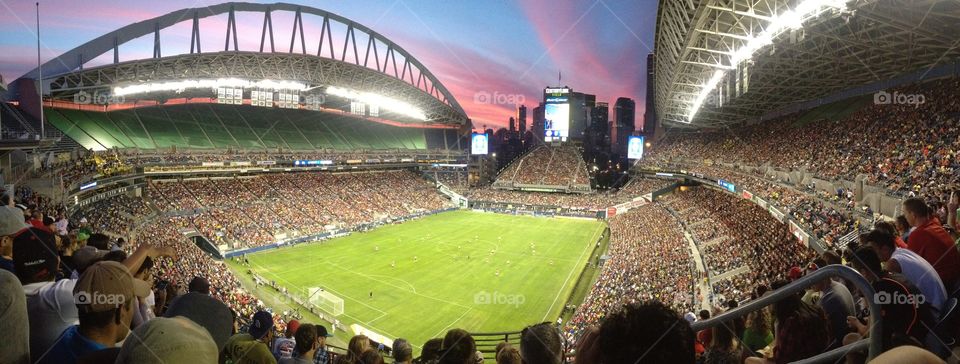 Century link field in Seattle Washington. The sun setting over this soccer match was astounding. Packed with so many fans. 