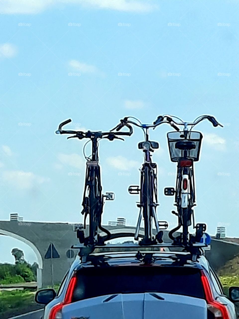 three bicycles on top of a car