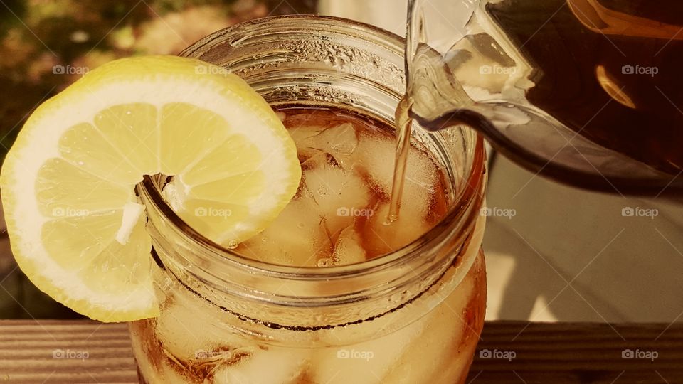 Pouring iced tea in jar