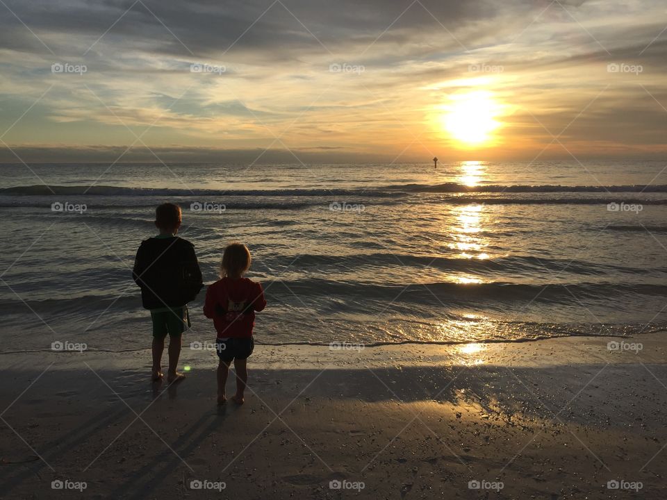 Sunset on the beach with the kids on a family vacation 