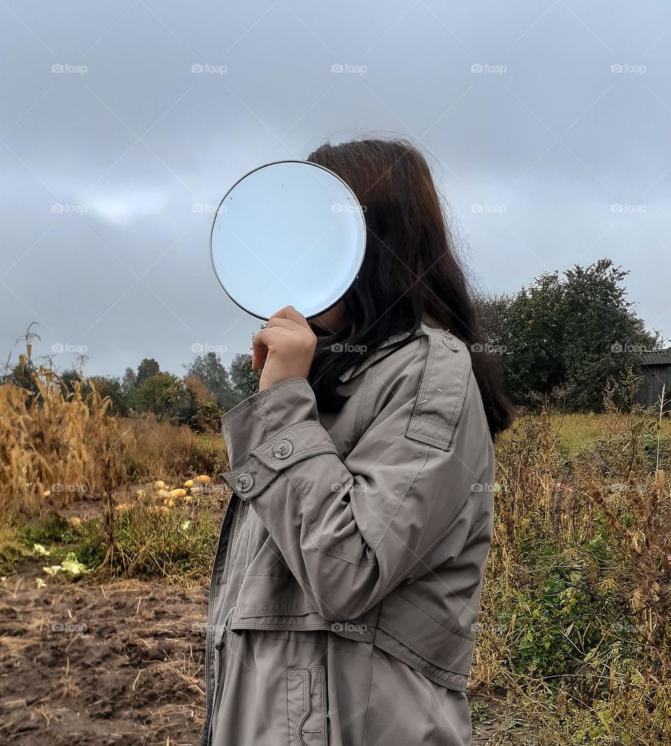 girl with a mirror instead of a face with a reflection of the sky