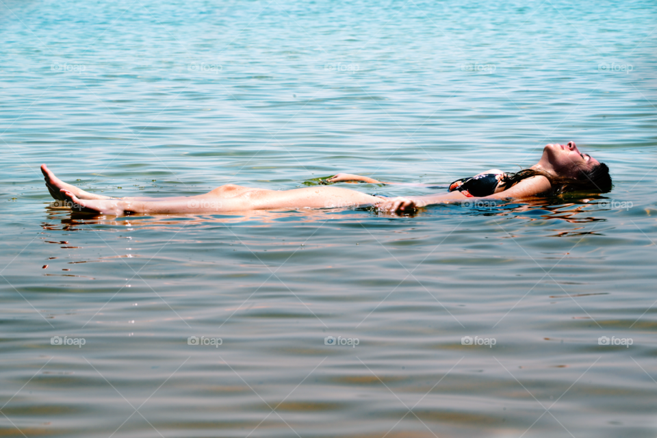 Woman lying on water