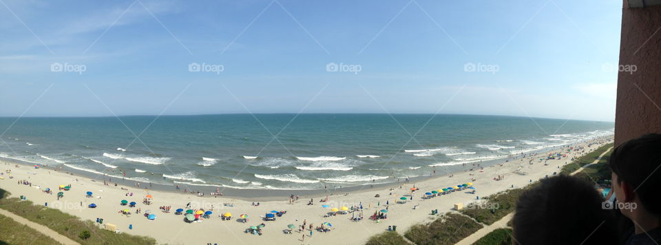Sunny day at Myrtle Beach. Look at those beach-goers down there having a blast. Oh and that view! The water looks so tempting, not to mention the never ending horizon... Breathtaking.