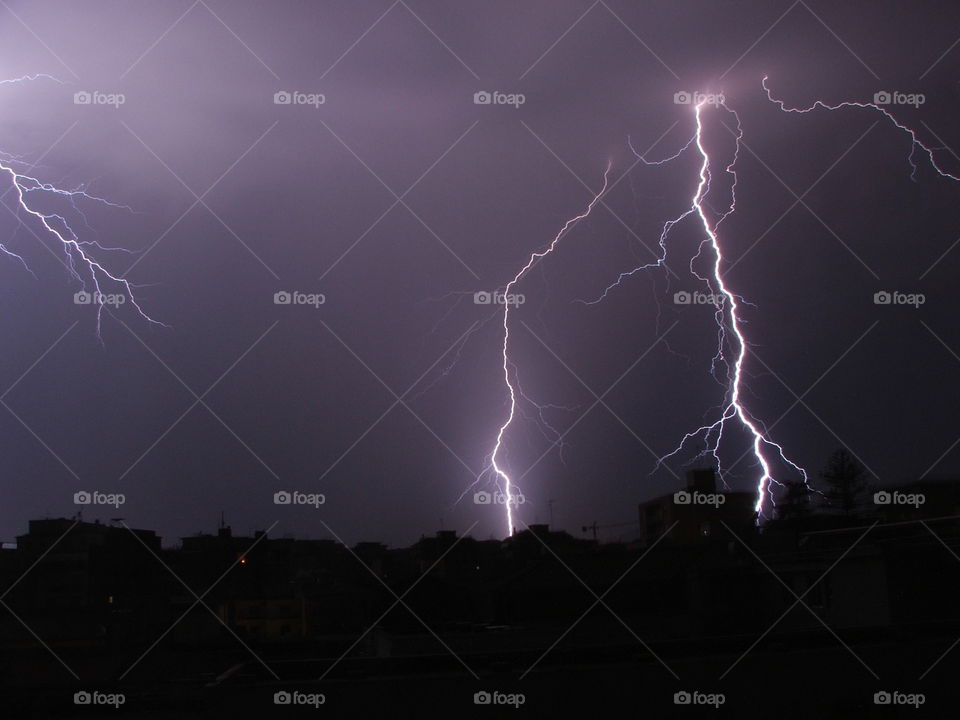 A lightning bolt photographed during a thunderstorm. to
Looking out the window I saw this show and I caught the fleeting moment. The origin of the phenomenon is also clearly seen. 
I was very lucky.