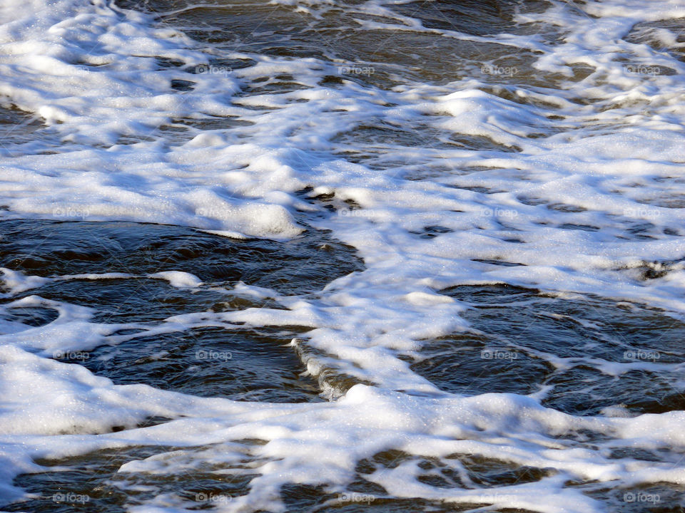 High angle view of surf on sea