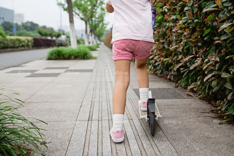 Kid using scooter 