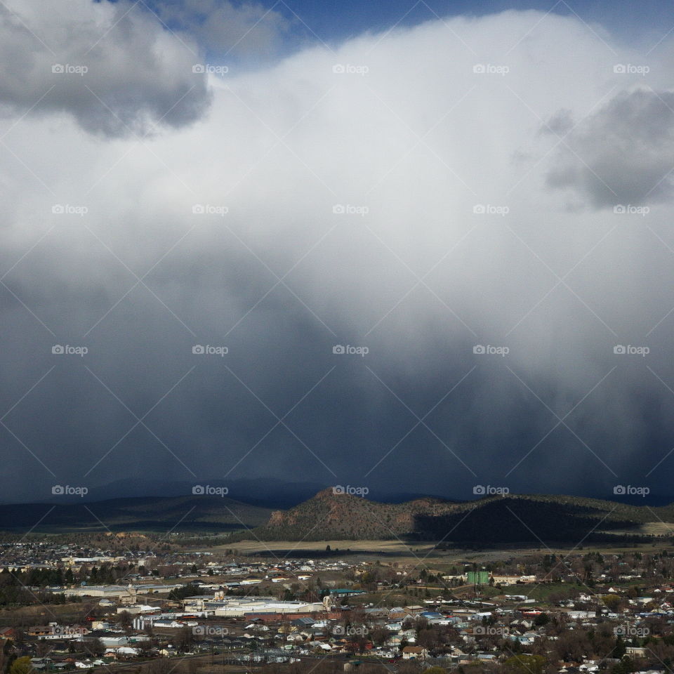 View from the Ochoco State Scenic Viewpoint of the town of Prineville, home of a growing technology sector, in Central Oregon with an intense sky from a rainstorm passing through. 