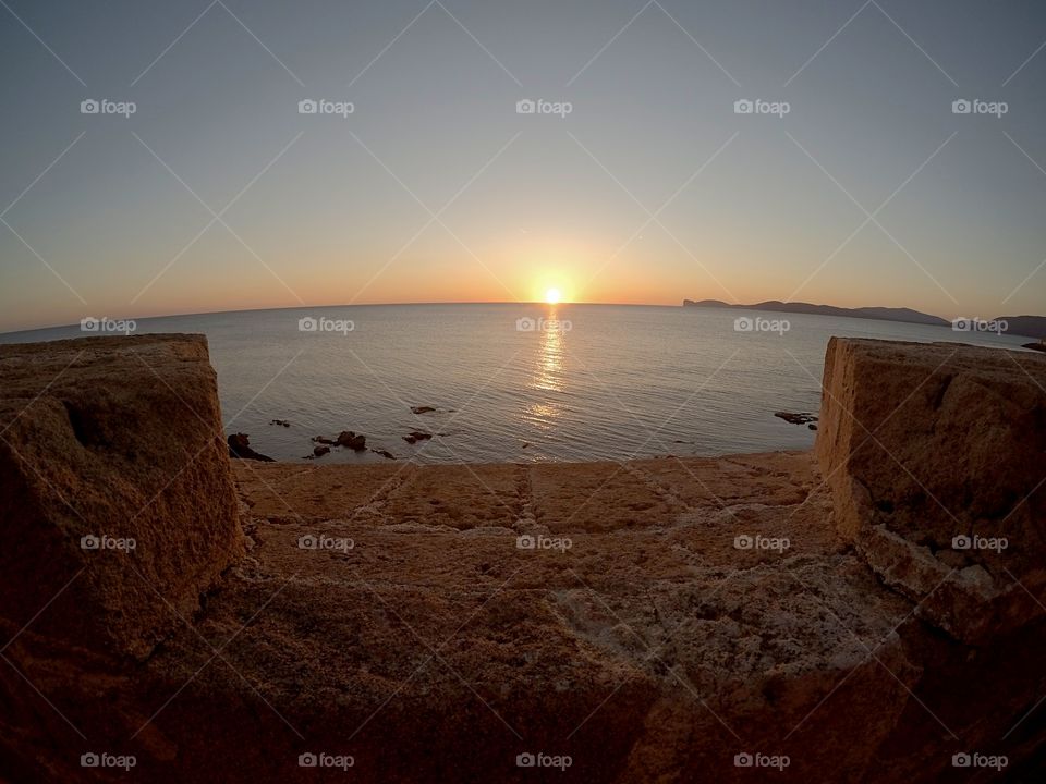 panoramic view of sunset shot by phone, betwen ancient fortification wall. Alghero, Italy