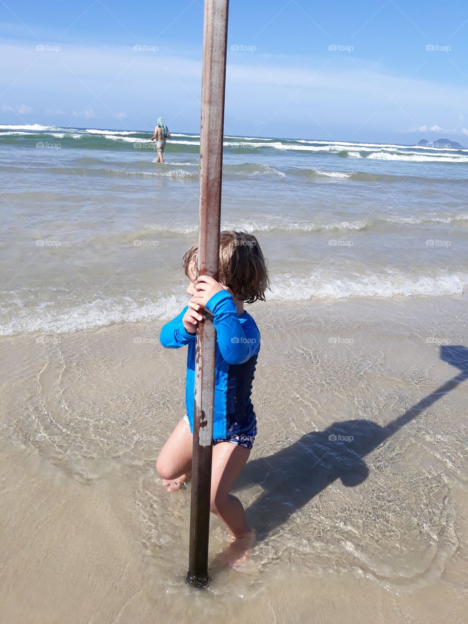 boy clinging to the beach board