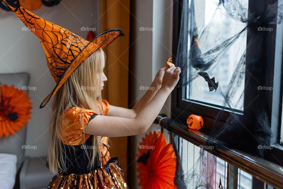 Happy kid celebrating Halloween at home 