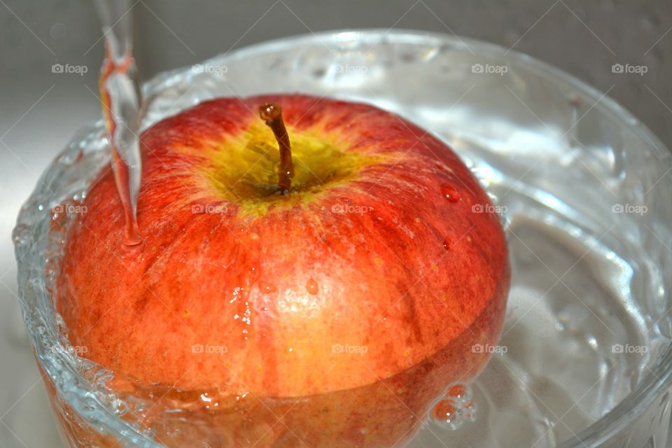 Close-up of water pouring on apple