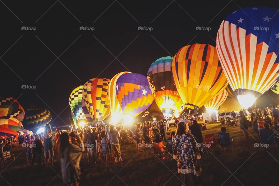 The Balloon Glow at the Great Texas Ballon Race, an annual event. A field of hot air balloons lit up at night.