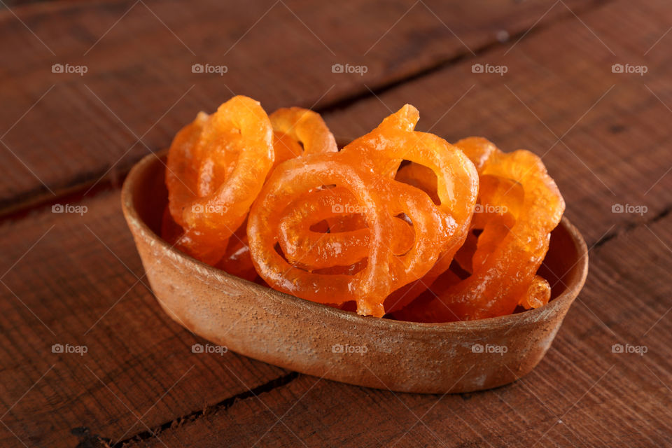India sweet Jalebi made of gram flour, deep fried and dipped in sugar syrup.
