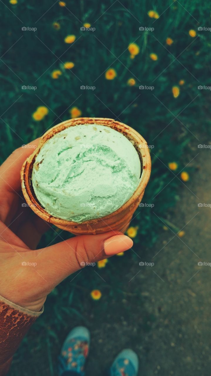 Woman holding green ice cream cone