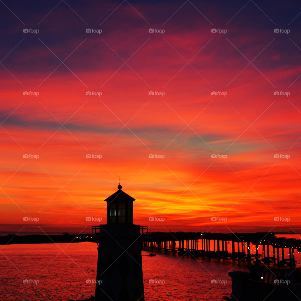 Silhouette of lighthouse during sunset