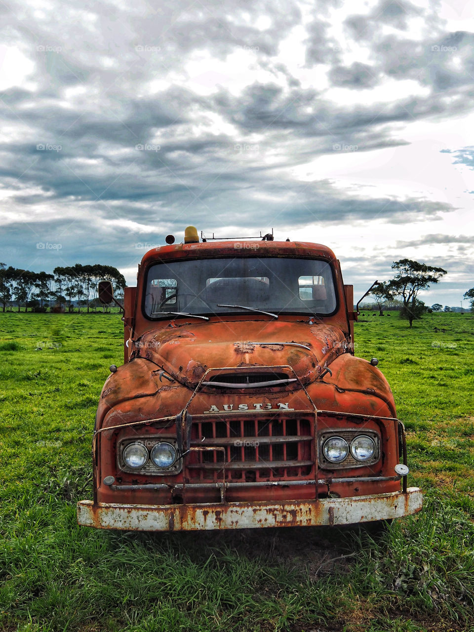 Red Austin truck in a farm field 