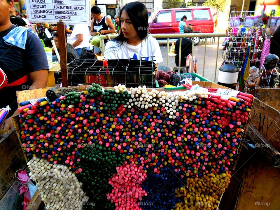 street vendor in quiapo selling colored candles