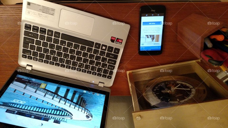 laptop cell phone and pencils and pens are all set