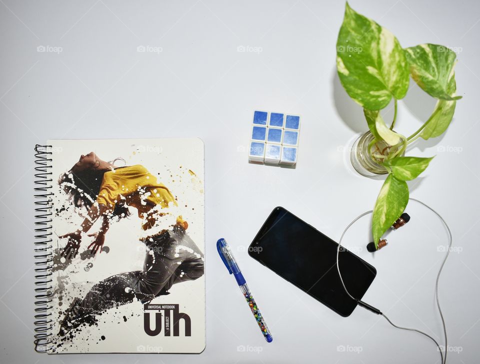 Notebook, pen, cell phone, headphones, plant, Rubik cube, study, student