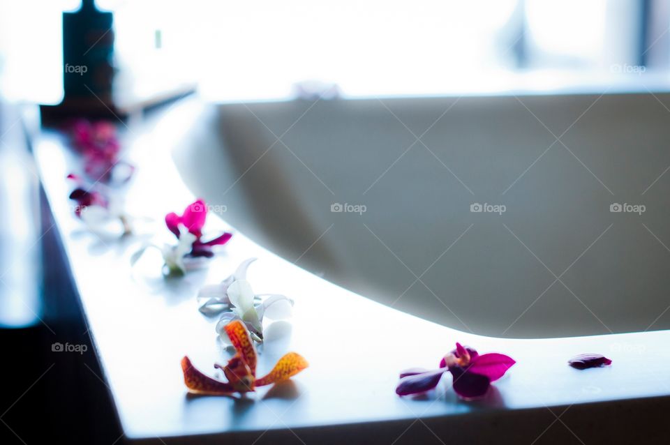Tropical flowers around the edge of the bathtub in our private villa in Bora Bora at the Fourseasons 