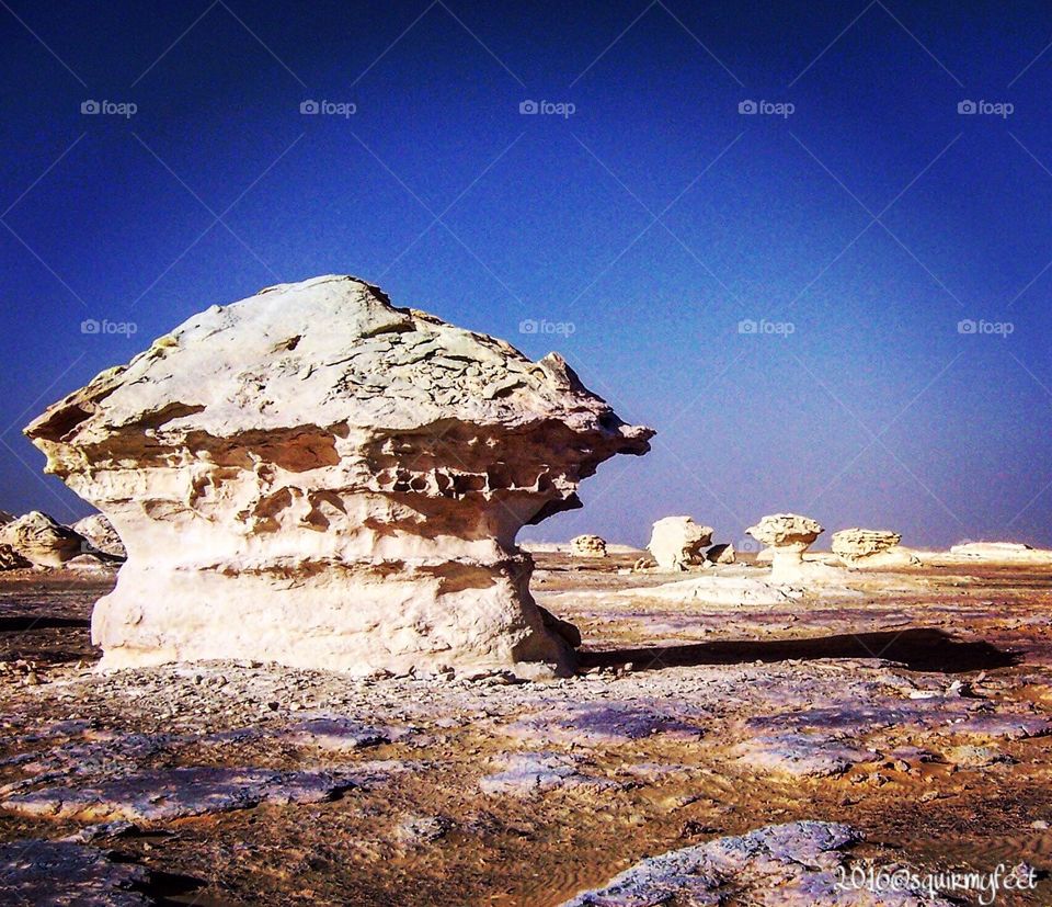 It's a national park of Egypt called the White Desert. It has massive chalk rock formations created as a result of occasional sandstorms in the area.