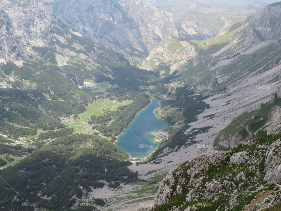 Mountain lake in valley seen from above summer hiking