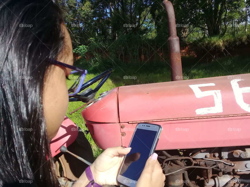 Young girl using Cell Phone in the field.  Moto G