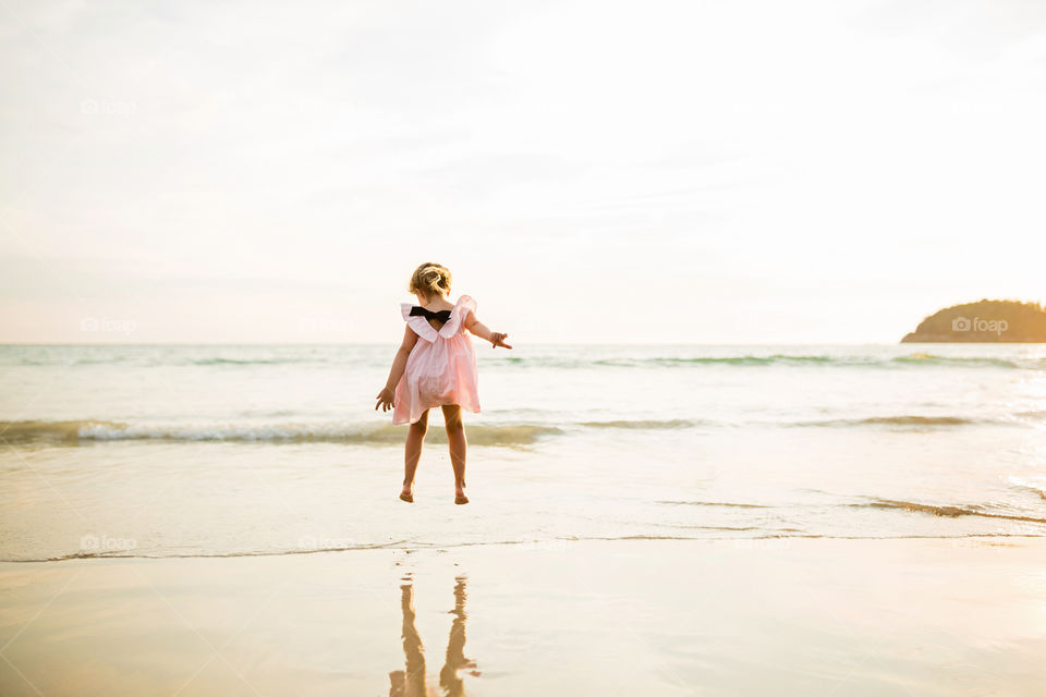 Girl jumping on the beach 