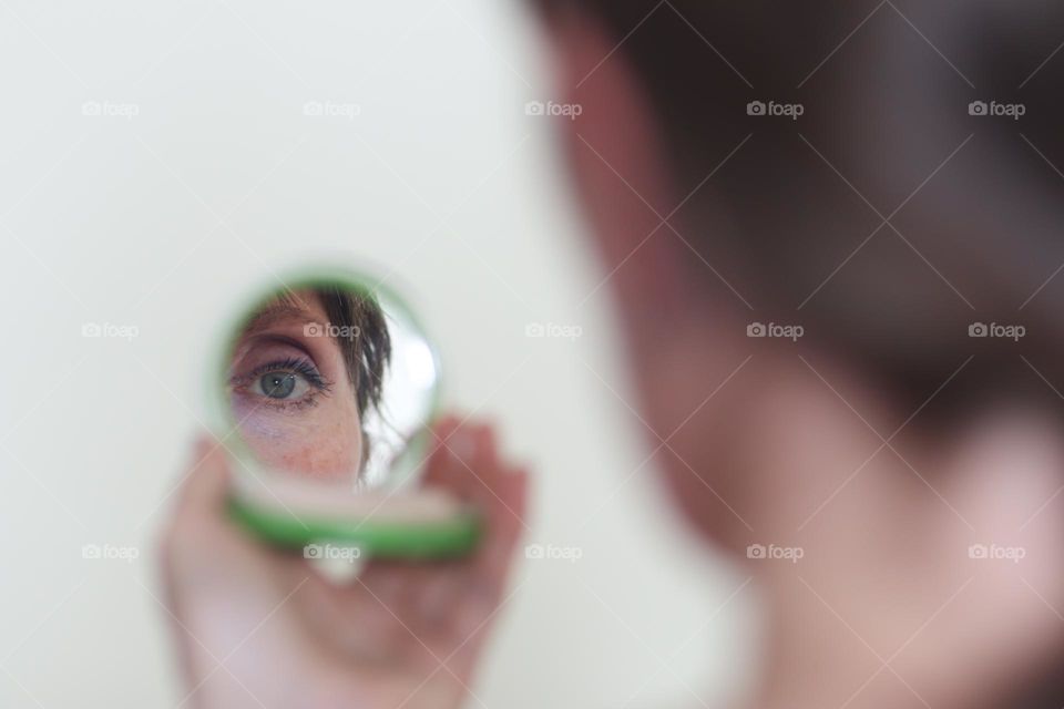 Reflection of a woman's eye with lilac shades