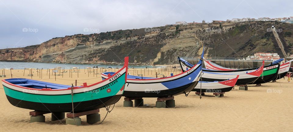 Colourful wooden boats on the beach at Nazaré 