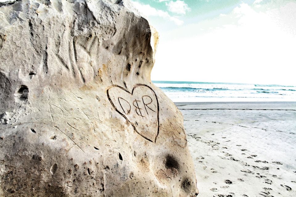 D & R carved into the rock at the beach