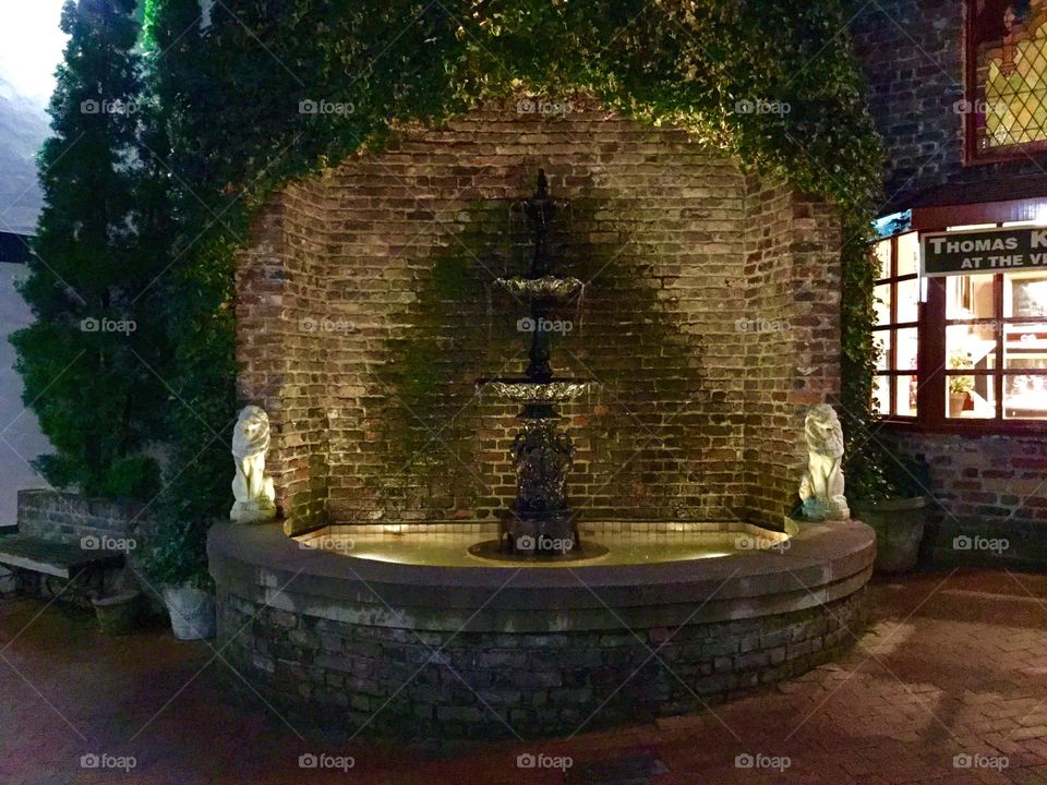 Fountain against brick wall outdoors