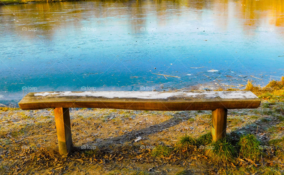 Frozen lake and snow on the bench