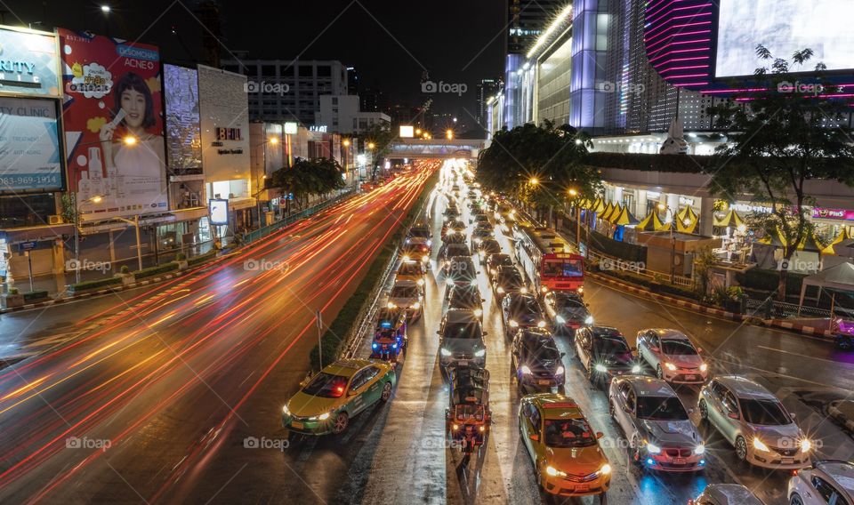 Beautiful Vehicle headlamp light at U turn road in front of the most famous shopping center MBK , Bangkok Thailand