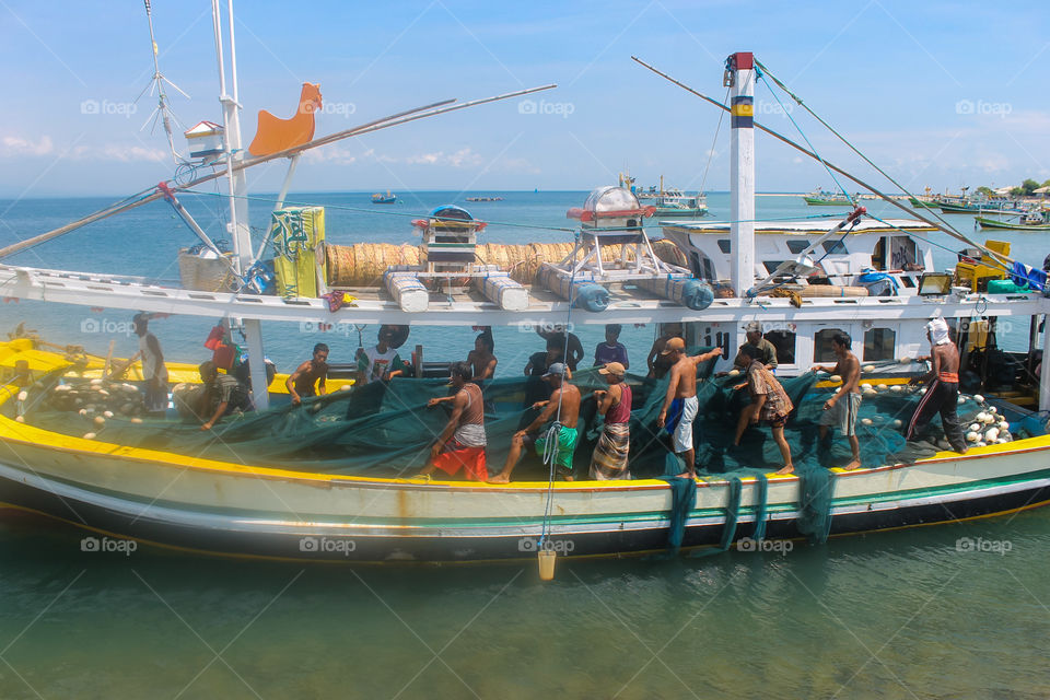 The fishermen prepare fishing nets before going to sea