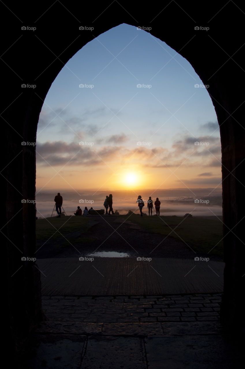 sunrise view through the arch of Glastonbury Thor