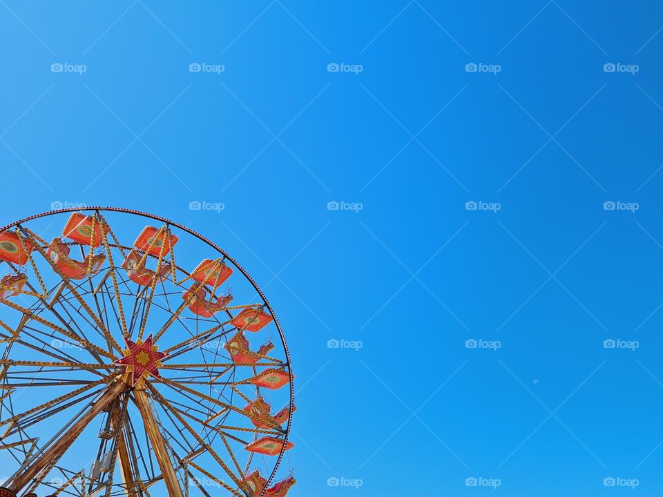 detail of ferris wheel and blue sky