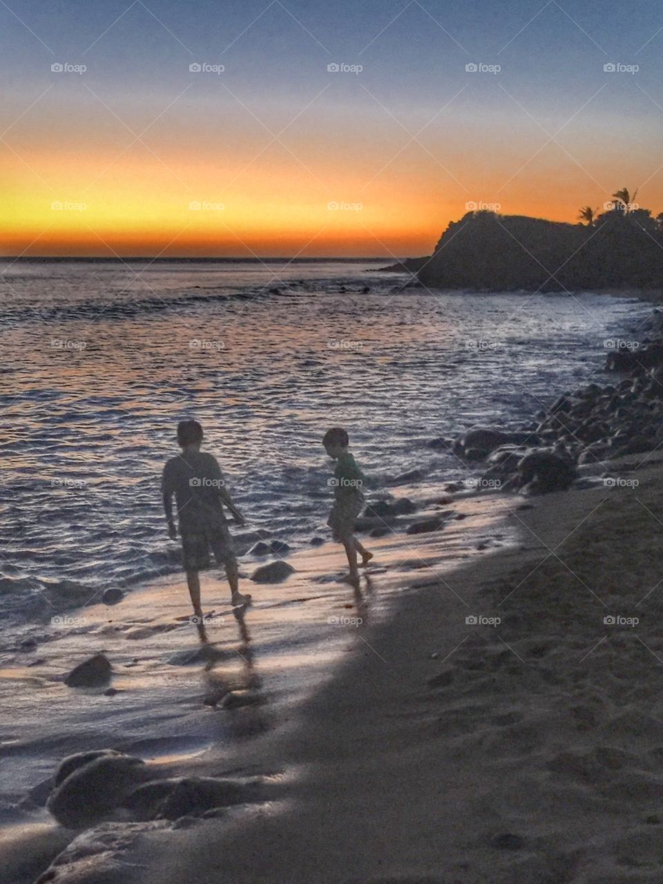 Kids on the beach at dusk