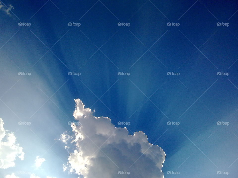 Blue sky. The sun was hiding behind a cloud.