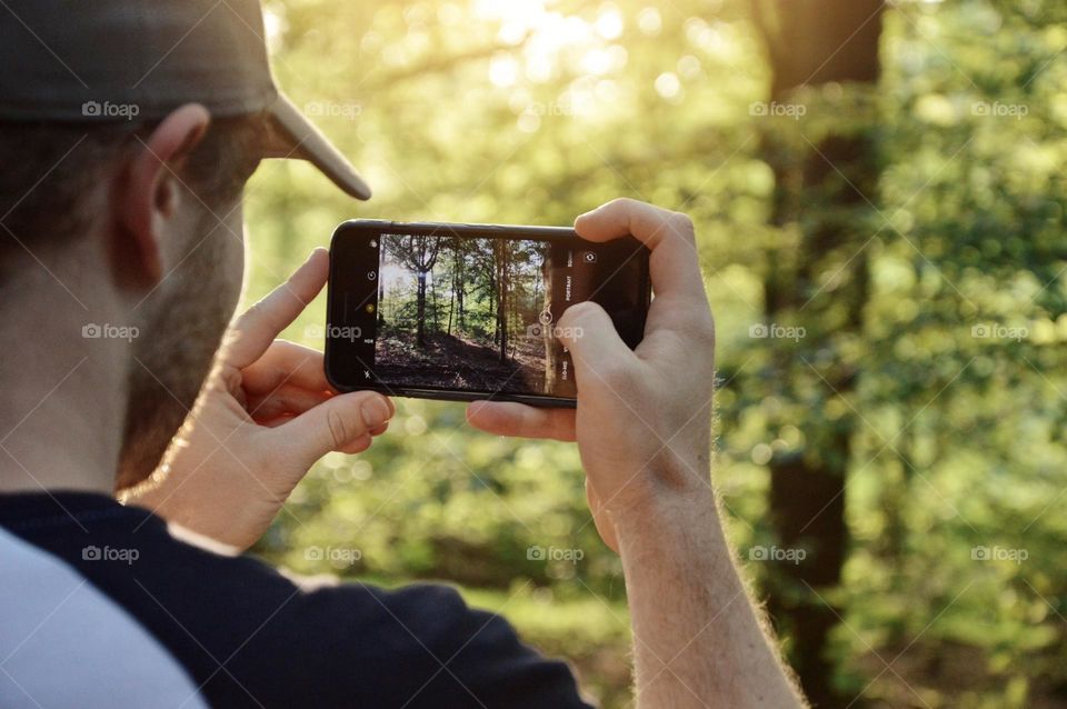 A man using his phone to take a photo