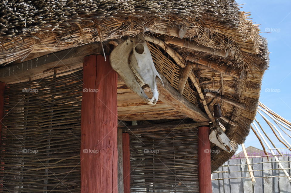 A totem horse's head hangs outside an Iron Age Roundhouse. The Celtic Goddess Epona was worshipped by the Celts. she was depicted as a white pony.