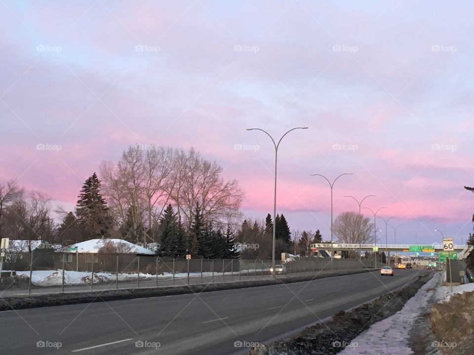 Lovely pink clouds in a morning on a highway