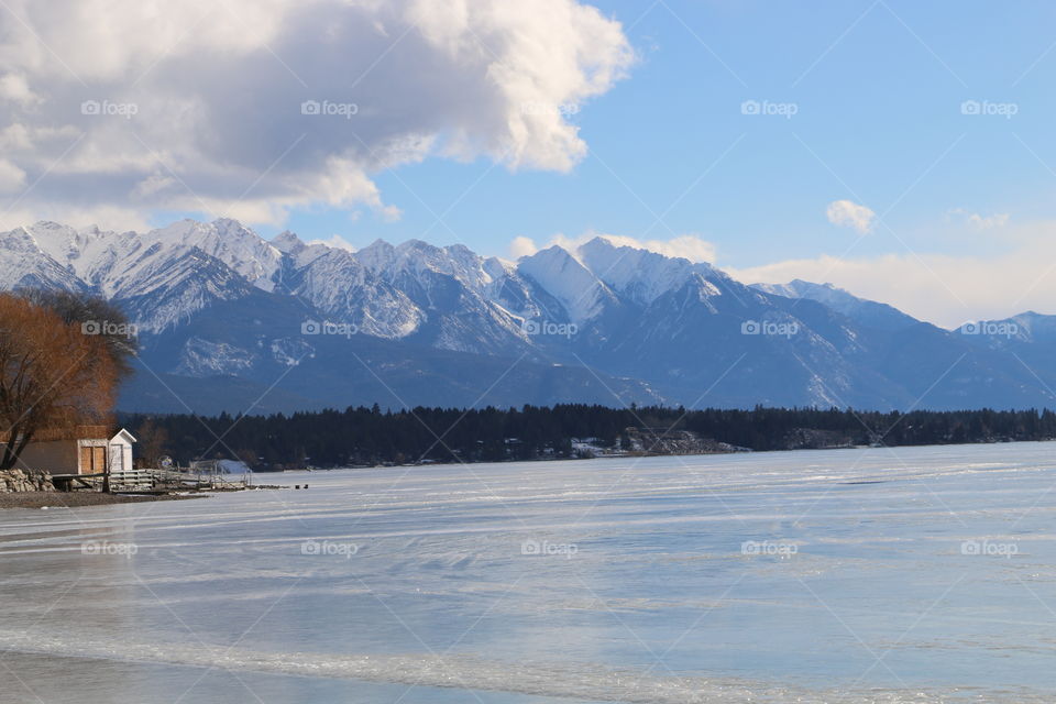 Snowy Mountains over Invermere and a lake