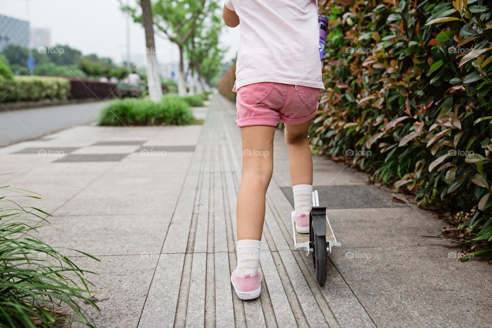 Kid riding on scooter 