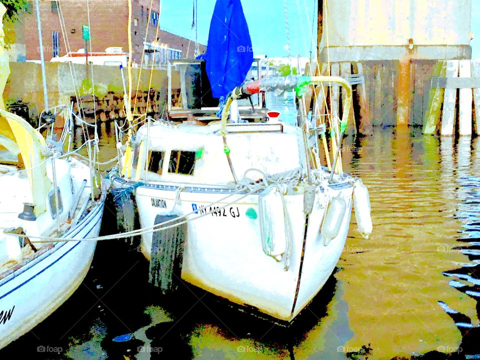 Sailboats in the waters of the East River at Newtown Creek in Long Island City, Queens as the sun is about to set casting a golden glow over everything. Photo from 2018. Hypnotic Productions