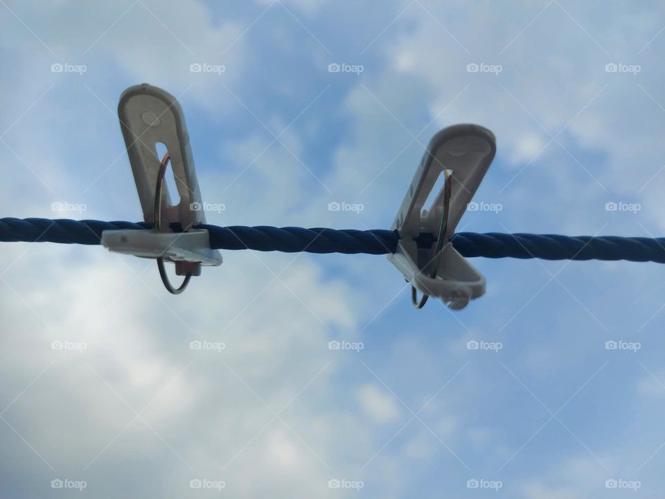 Clothespins, clotheslines against the sky background