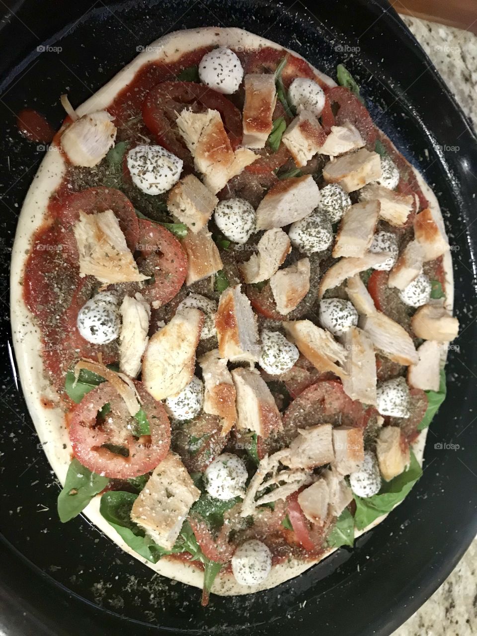 Spinach tomato  mozzarella and chicken pizza 