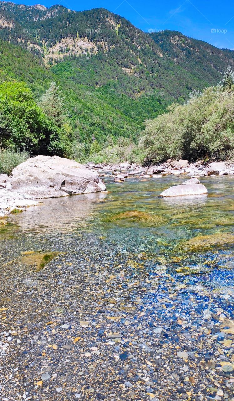 Transparent water of the river in the mountain.