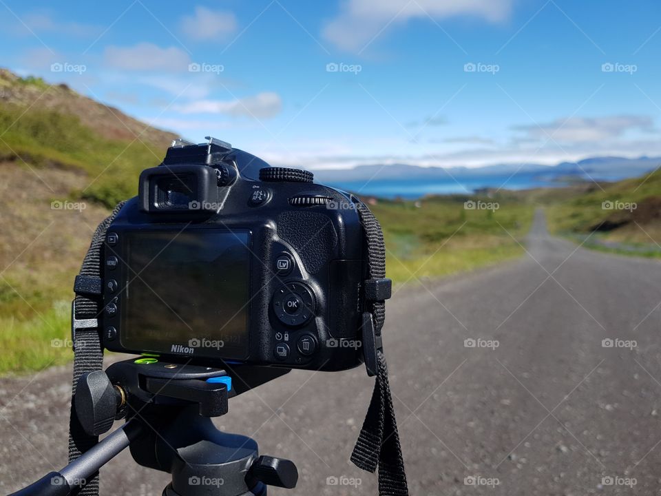 Nikon DSLR Camera with tripod and a great view on Icelandic roads and a lake