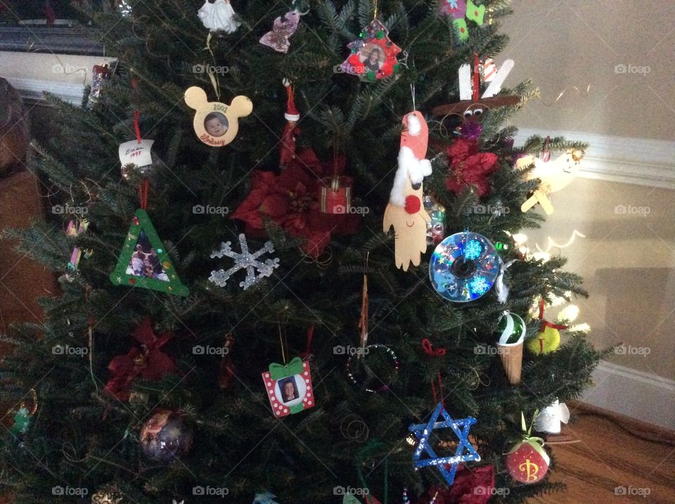 Christmas tree cheerfully decorated with family ornaments 